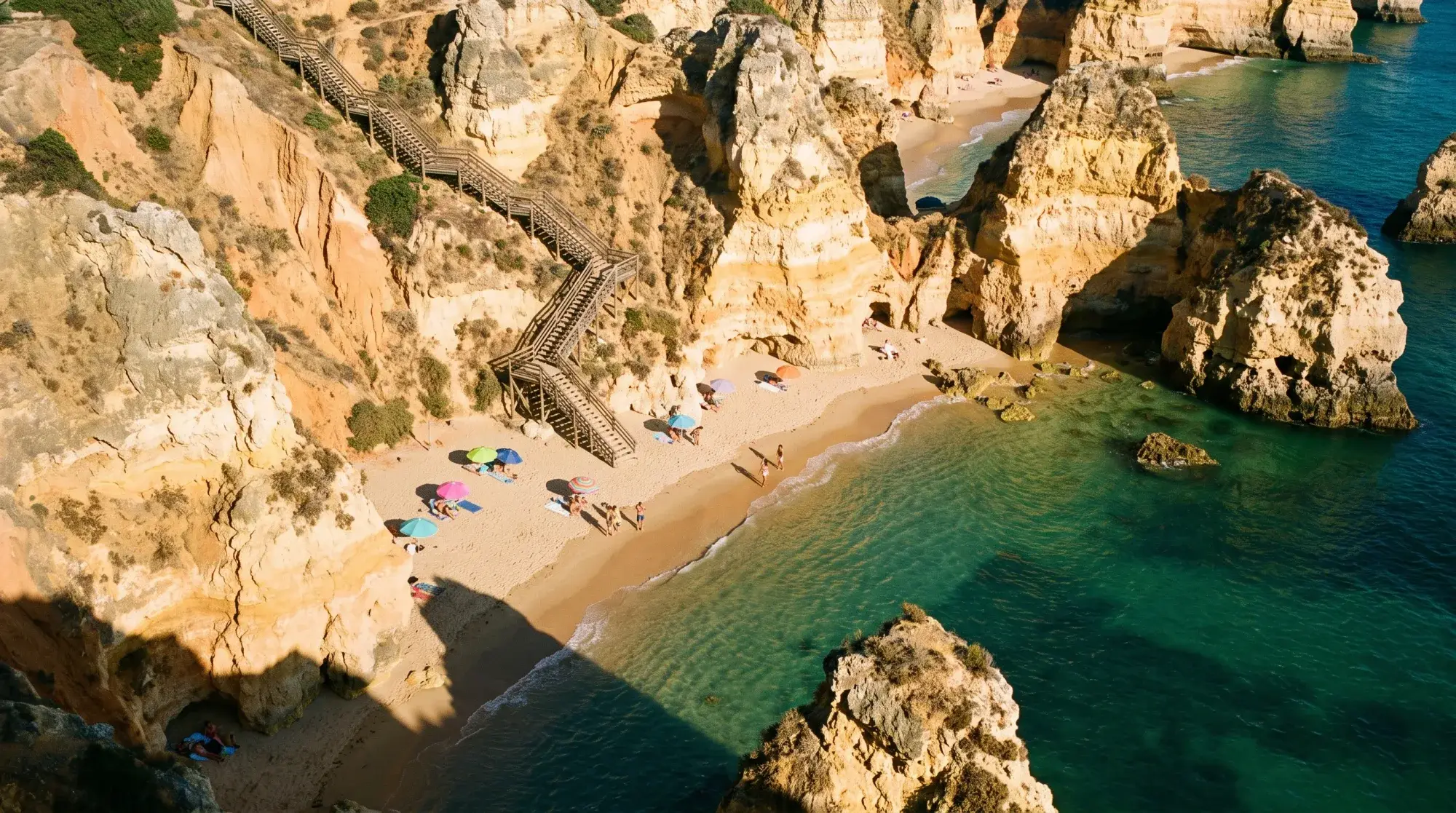Illustrative image: sandy cove between sandstone cliffs, seen from above